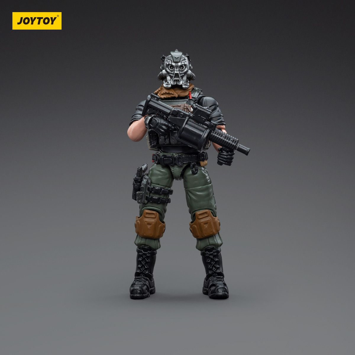 Toy figure of a soldier in tactical gear with a rifle, standing on a gray background with 'JOYTOY' branding.