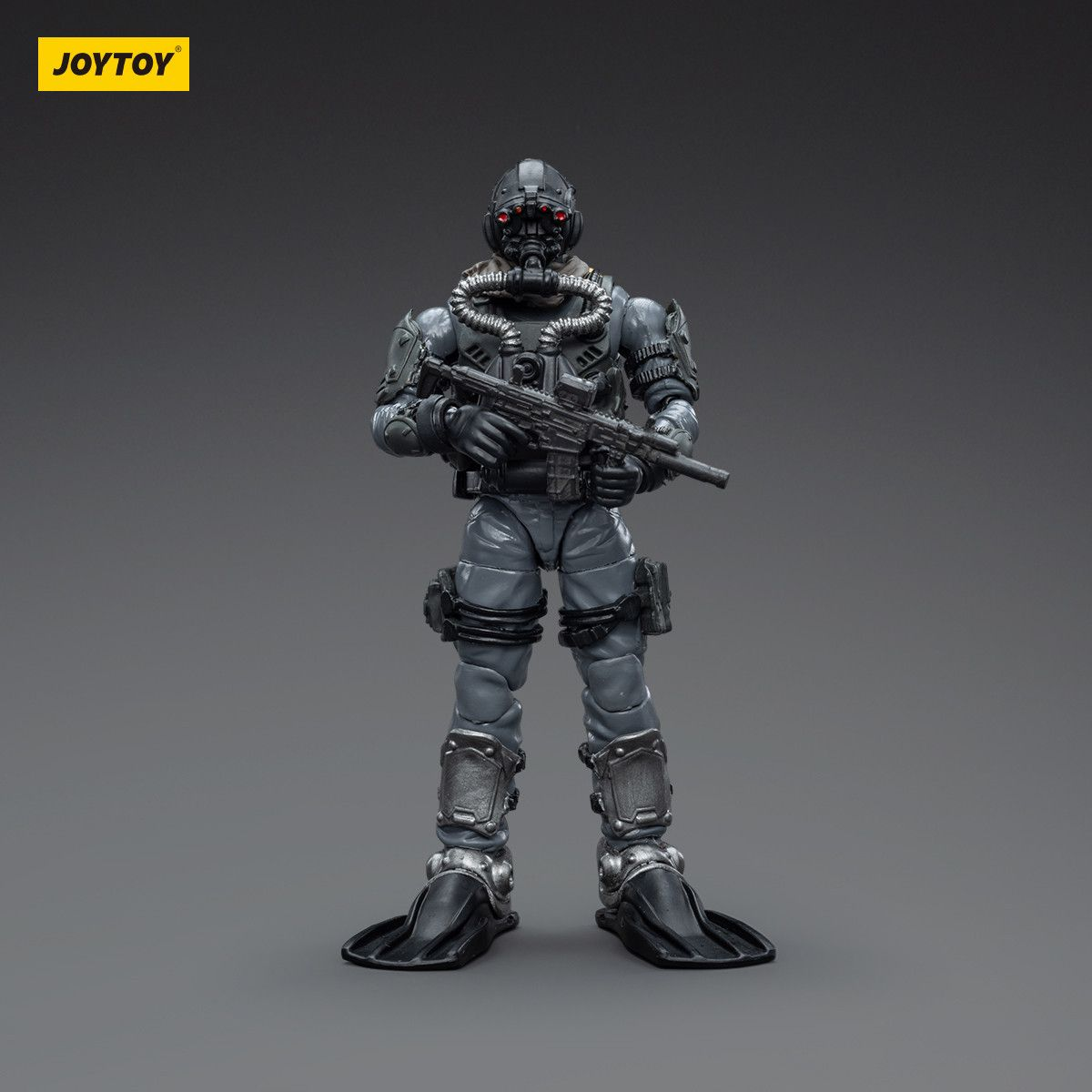 Toy figure of a futuristic soldier in gray armor holding a weapon on a gray background with 'JOYTOY' branding.