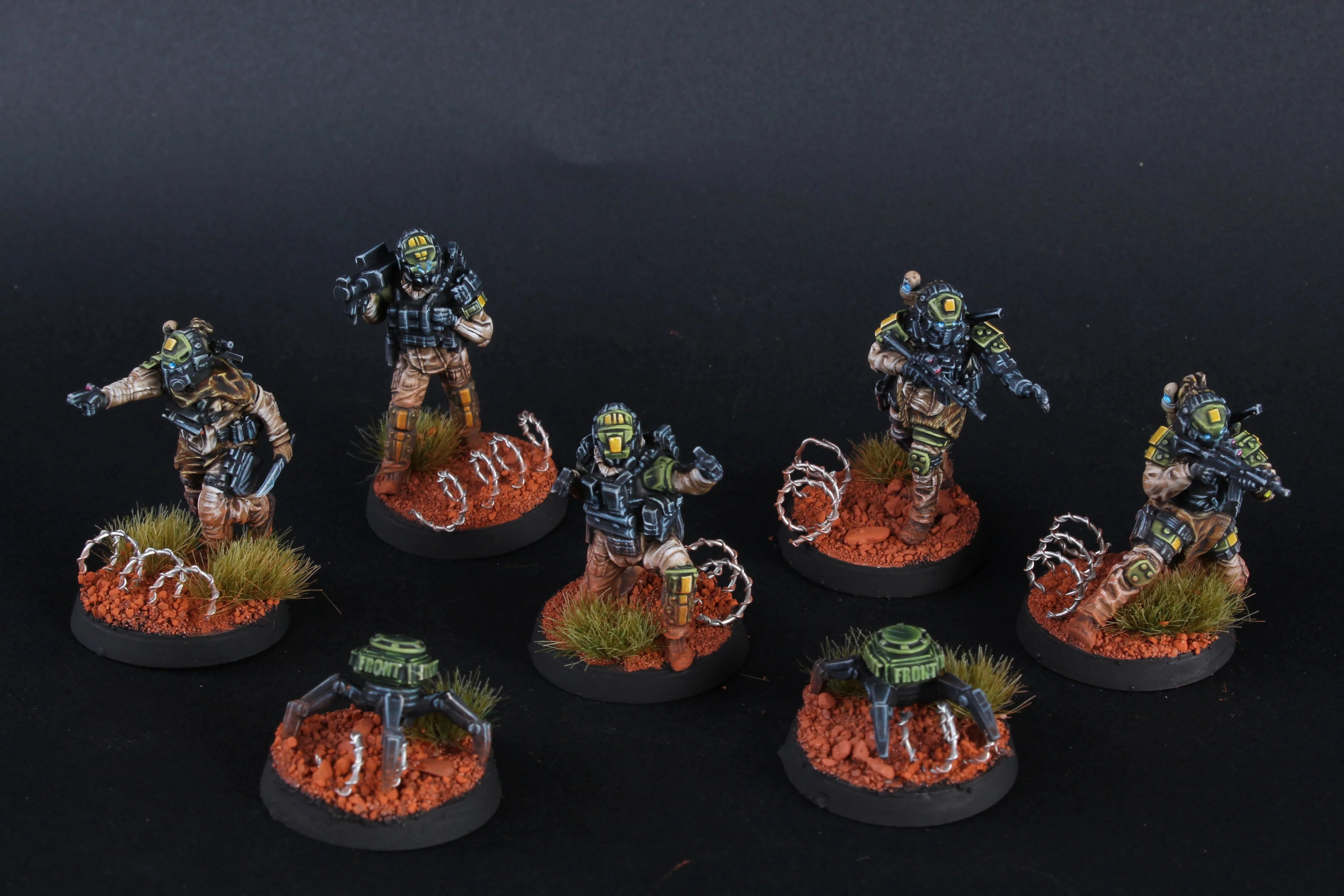 Set of miniature figures on round bases with a dark background