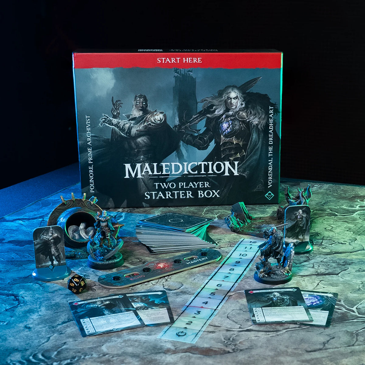 Board game set with 'Malediction' starter box and game pieces on a dark surface