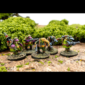 Miniature figures in green uniforms with weapons on a natural background