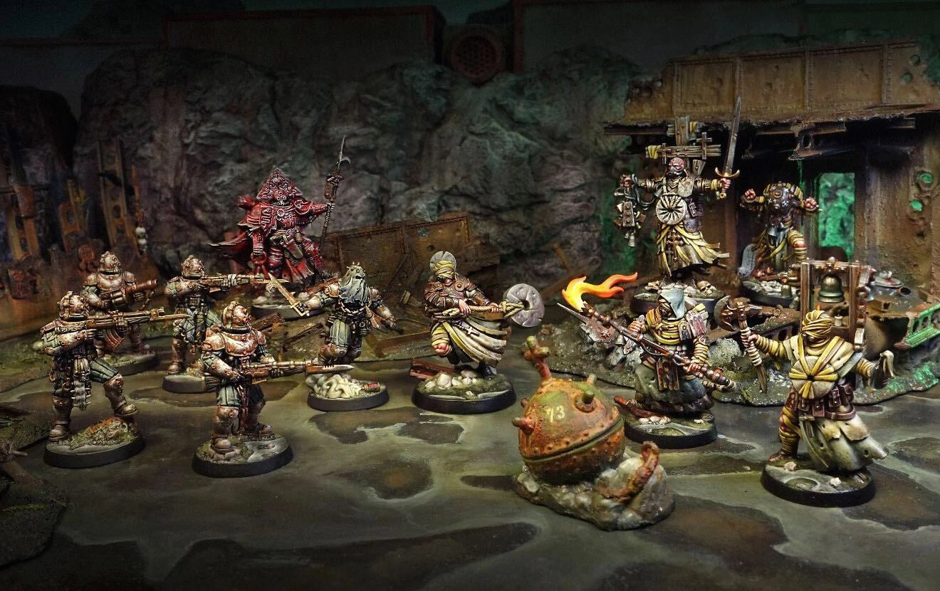 Miniature figurines in a fantasy setting with detailed backgrounds