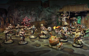 Miniature figurines in a fantasy setting with detailed backgrounds