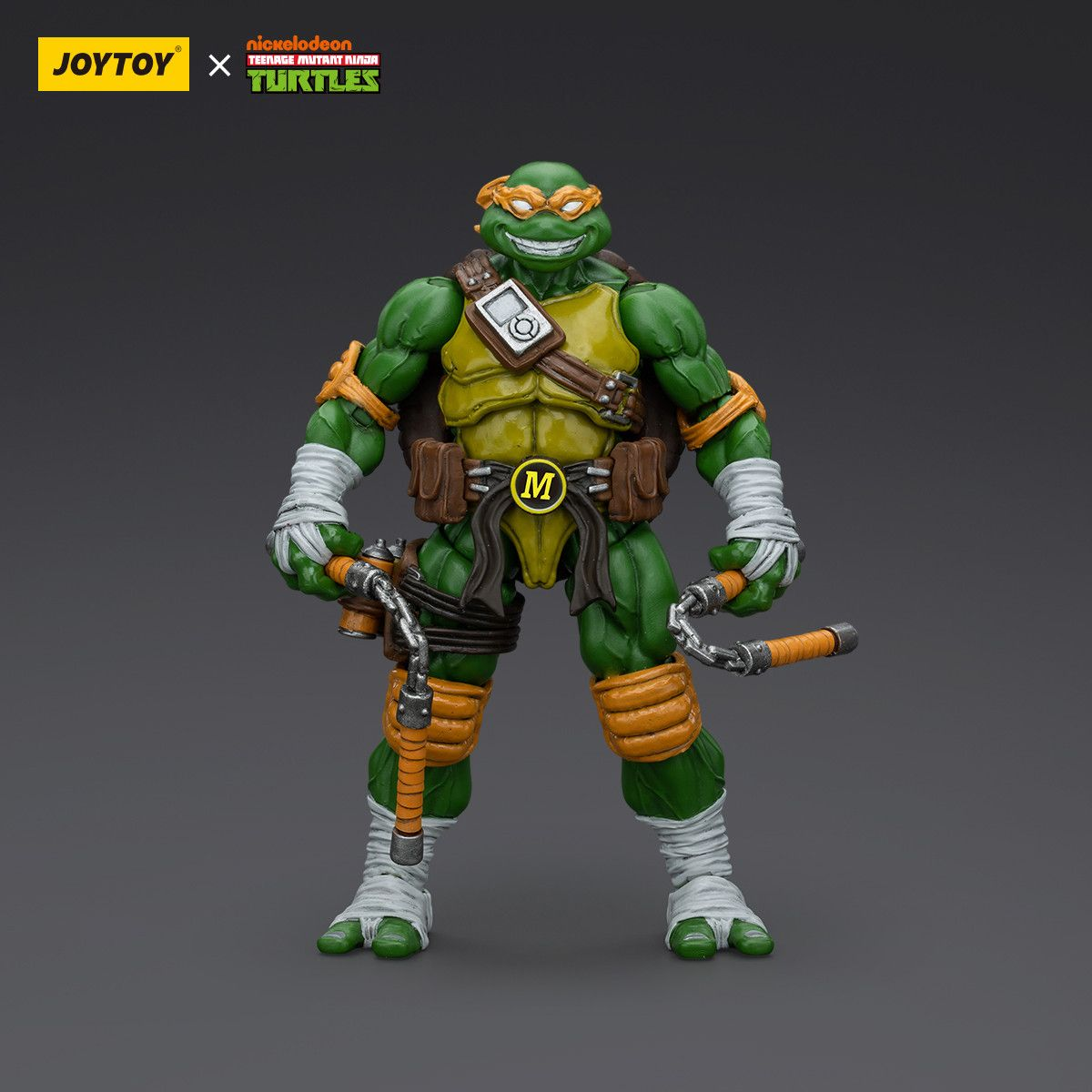 Toy figure of a green turtle with orange accents on a gray background, featuring Joytoy and Nickelodeon logos.