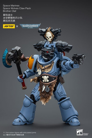 Toy figure of a Space Marine from Warhammer series on a gray background