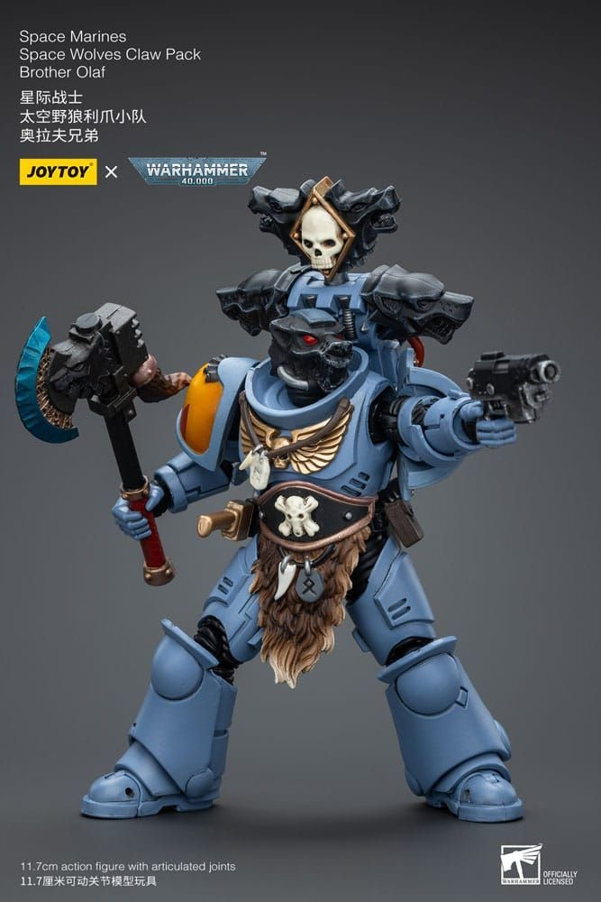 Toy figure of a Space Marine from Warhammer series on a gray background