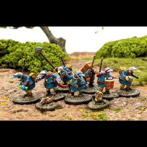 Miniature figures in blue armor with various weapons and accessories on a natural landscape background.